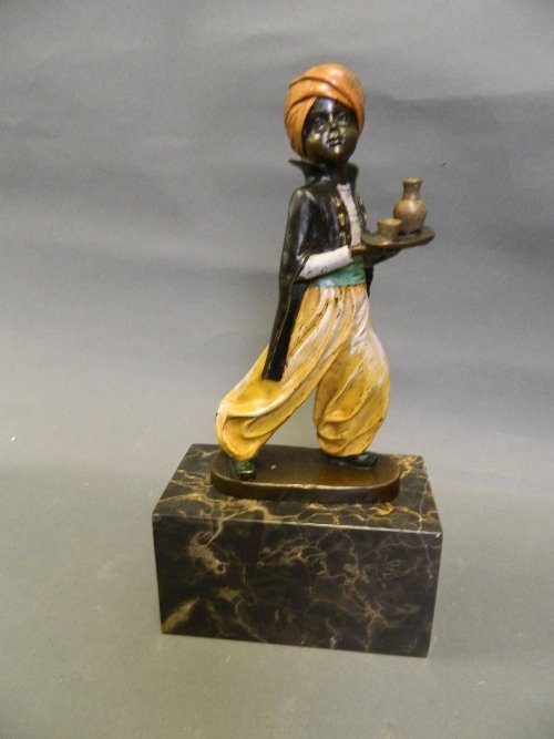 A cold painted bronze figure of a Moor holding a tray,: A cold painted bronze figure of a Moor holding a tray, on a rectangular marble base, 10Â½'' high