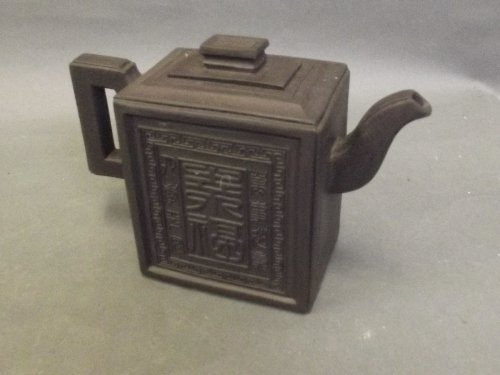 A Chinese rectangular form Yixing teapot with character: A Chinese rectangular form Yixing teapot with character decoration to sides and lid, impressed mark to base, 6Â¼'' x 4Â½''