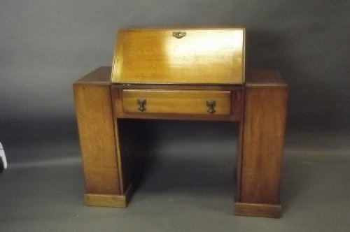 An Art Deco oak bureau with open bookshelf sides, 42'': An Art Deco oak bureau with open bookshelf sides, 42'' x 15Â½'', 38'' high