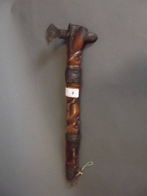 An antique African axe with a carved wood and metal: An antique African axe with a carved wood and metal bound handle, 15½'' long