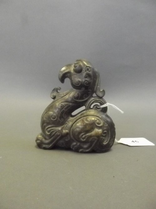 A Chinese bronze scroll weight in the form of a: A Chinese bronze scroll weight in the form of a mythical beast, 4'' high