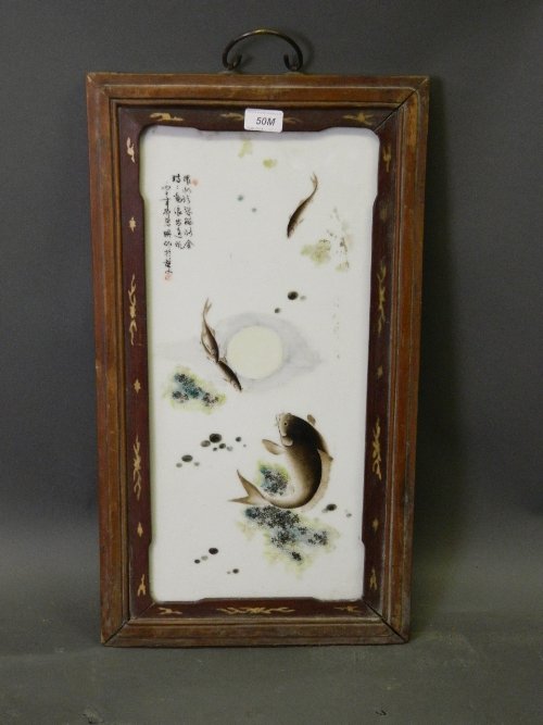 A Chinese porcelain panel in a hardwood frame with: A Chinese porcelain panel in a hardwood frame with painted enamel carp decoration, 13½'' x 24½''