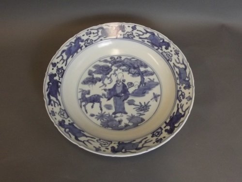 A Chinese blue and white lobed edge charger with: A Chinese blue and white lobed edge charger with painted Shao Lin decoration to centre and parading horses to rim, 6 character mark to base, 12'' diameter