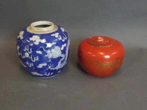 A Chinese blue and white ginger jar with cracked ice: A Chinese blue and white ginger jar with cracked ice and dragon decoration (lidless), and a Chinese orange ground pot and cover decorated with a mountain village scene, mark to base, ginger jar 5'' hi