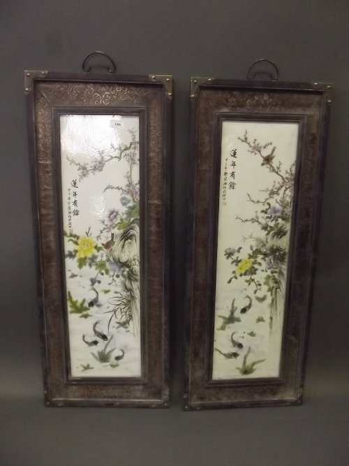 A pair of Chinese porcelain panels depicting birds in a: A pair of Chinese porcelain panels depicting birds in a flowering tree, mounted in wooden frames with gilt highlights, 37'' x 14½''