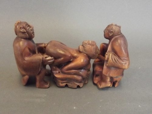 A 3 piece Japanese carved interlocking erotic netsuke: A 3 piece Japanese carved interlocking erotic netsuke figure group with Mother of Pearl inlaid character mark, 4'' long interlocked