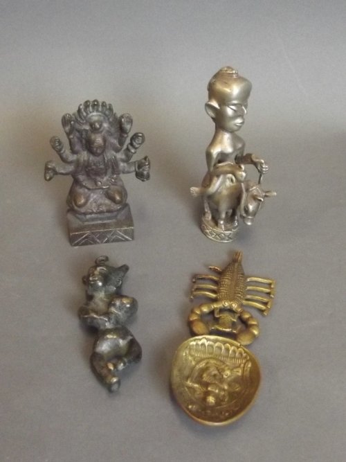 A collection of bronze and metal Votive figures, and a: A collection of bronze and metal Votive figures, and a brass tea caddy spoon (4)