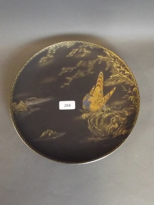 A Japanese black ground pottery charger painted with an: A Japanese black ground pottery charger painted with an Asiatic pheasant, mark to underside, 12'' diameter