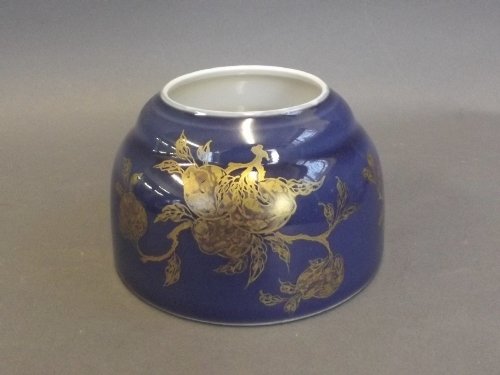 A Chinese blue ground porcelain inkwell with painted: A Chinese blue ground porcelain inkwell with painted gilt peach and pomegranate decoration, painted mark to base, 4¾'' diameter
