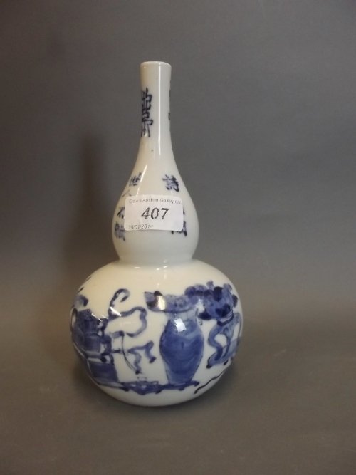 A C19th Chinese blue and white pottery vase with a: A C19th Chinese blue and white pottery vase with a slender neck, painted with precious objects, 4 character mark, 8¼'' high