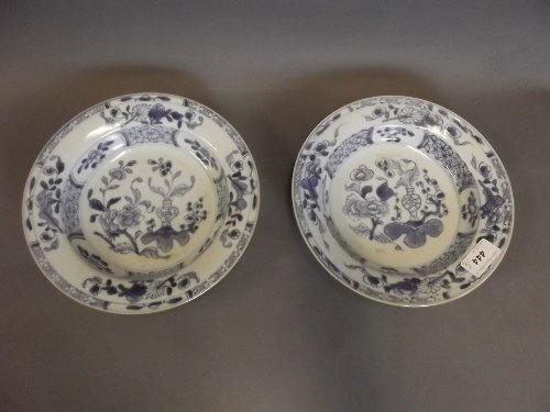 A pair of C18th Chinese blue and white porcelain bowl: A pair of C18th Chinese blue and white porcelain bowl painted with vases of flowers etc, 8¾'' diameter