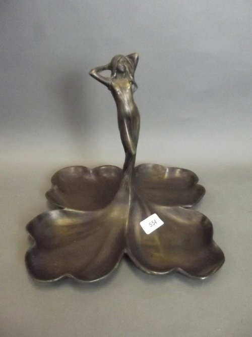 An Art Nouveau style brass centrepiece in the form of a: An Art Nouveau style brass centrepiece in the form of a maiden, 10½'' square