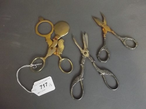 A pair of Continental 925 silver handled grape scissors: A pair of Continental 925 silver handled grape scissors marked 'Acier', another pair with ornate handles, and another gilt metal pair in the form of a cockerel
