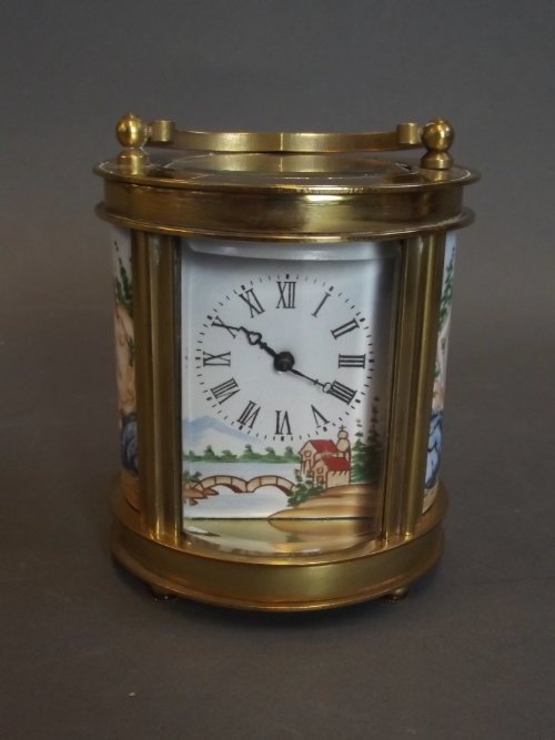 A small oval brass carriage clock decorated with enamel: A small oval brass carriage clock decorated with enamel nude to side panels, 3¼'' high