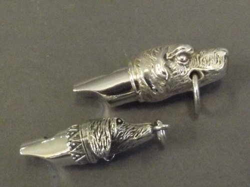 Two silver whistles in the form of dogs, 1½'' long: Two silver whistles in the form of dogs, 1½'' long
