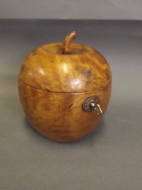 A treen tea caddy carved in the form of an apple, 5'': A treen tea caddy carved in the form of an apple, 5'' high