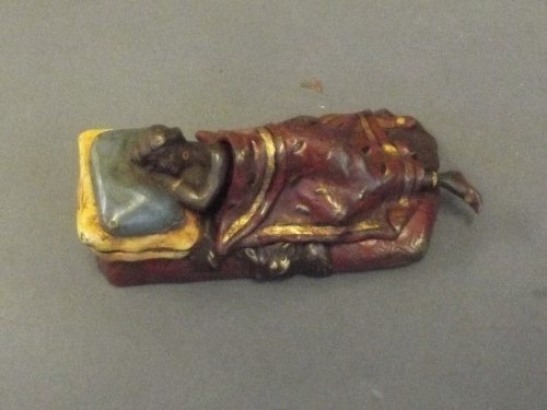 A cold painted bronze figure of a naked sleeping girl: A cold painted bronze figure of a naked sleeping girl under a removable blanket, 4'' long