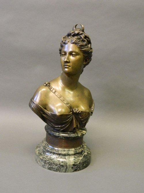A C19th large bronze bust of Diana, signed Houdon, on a: A C19th large bronze bust of Diana, signed Houdon, on a marble base, 21'' high