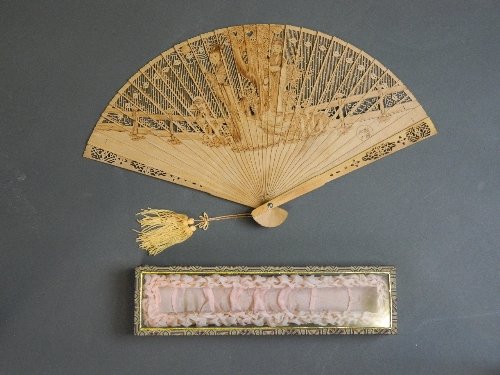 A superb Chinese carved, pierced and sepia painted: A superb Chinese carved, pierced and sepia painted sandalwood fan, cased, 9'' long