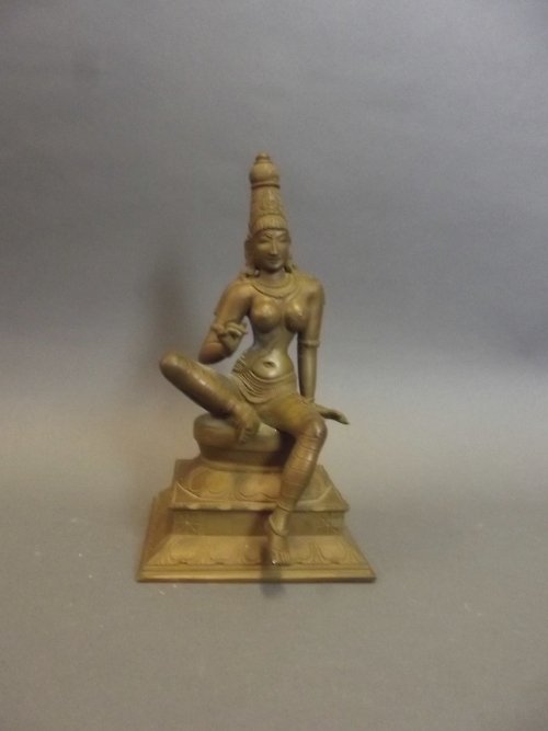 A C19th Indian bronze figure of a female deity on a: A C19th Indian bronze figure of a female deity on a stepped base, 9'' high