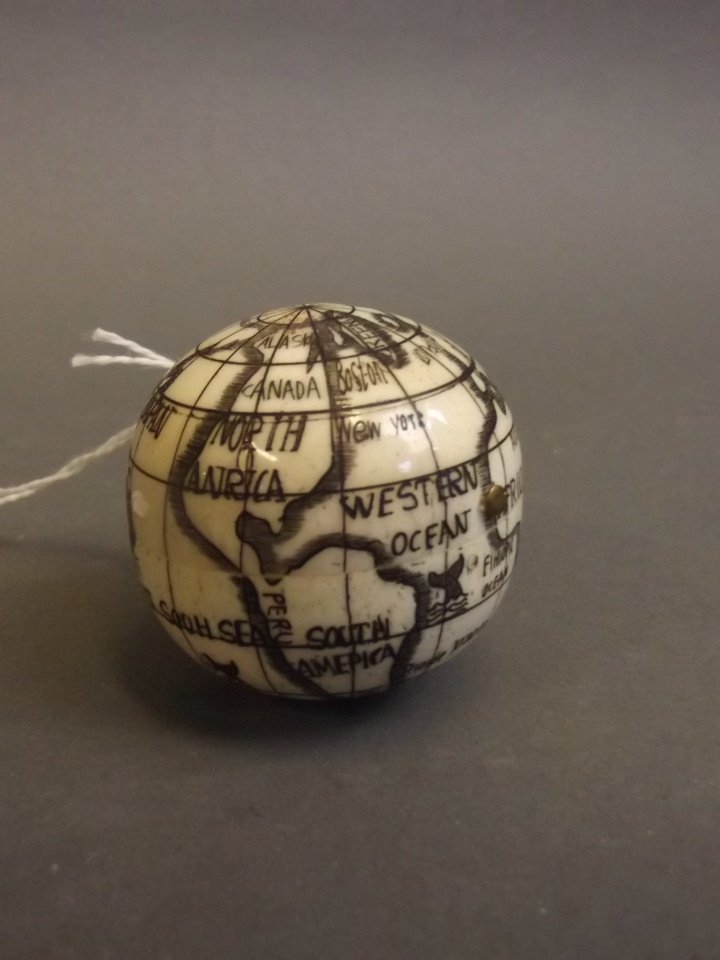 An engraved bone globe opening to reveal a compass,: An engraved bone globe opening to reveal a compass, 1½'' diameter