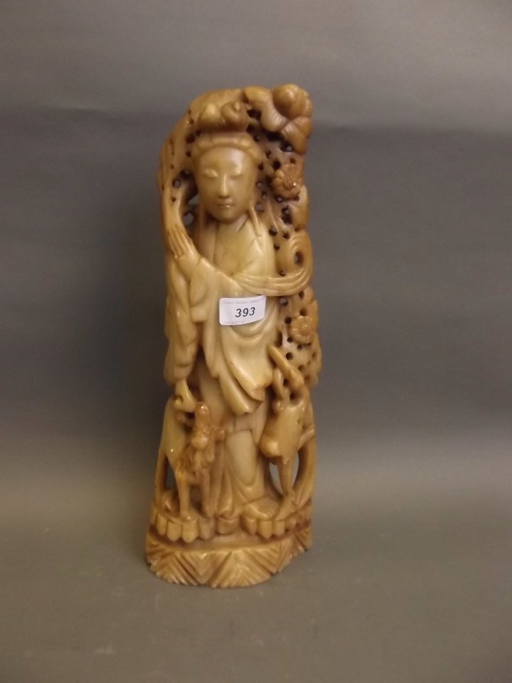A large Oriental carved soapstone figure with attendant: A large Oriental carved soapstone figure with attendant deer and crane, 15½'' high