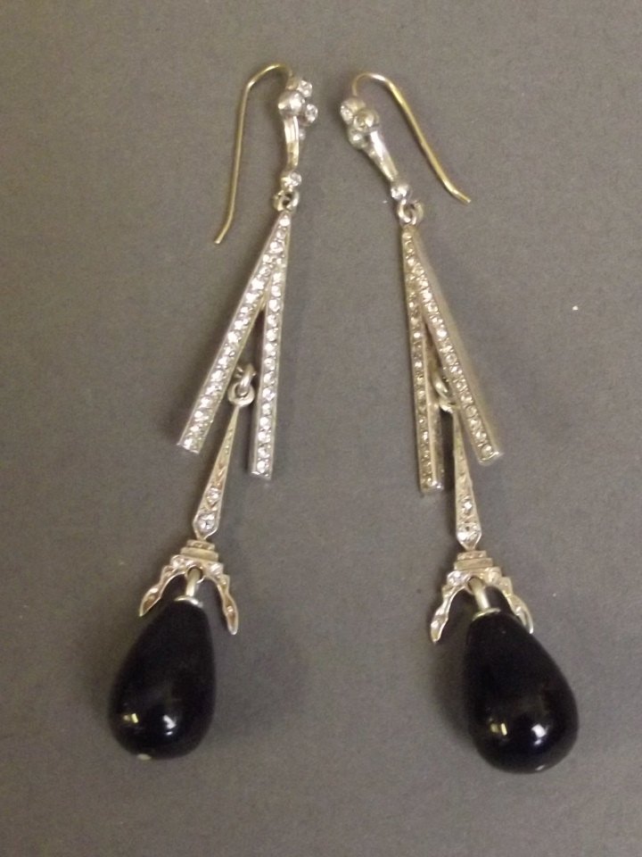 A pair of 9ct gold and silver drop earrings set with: A pair of 9ct gold and silver drop earrings set with onyx beads