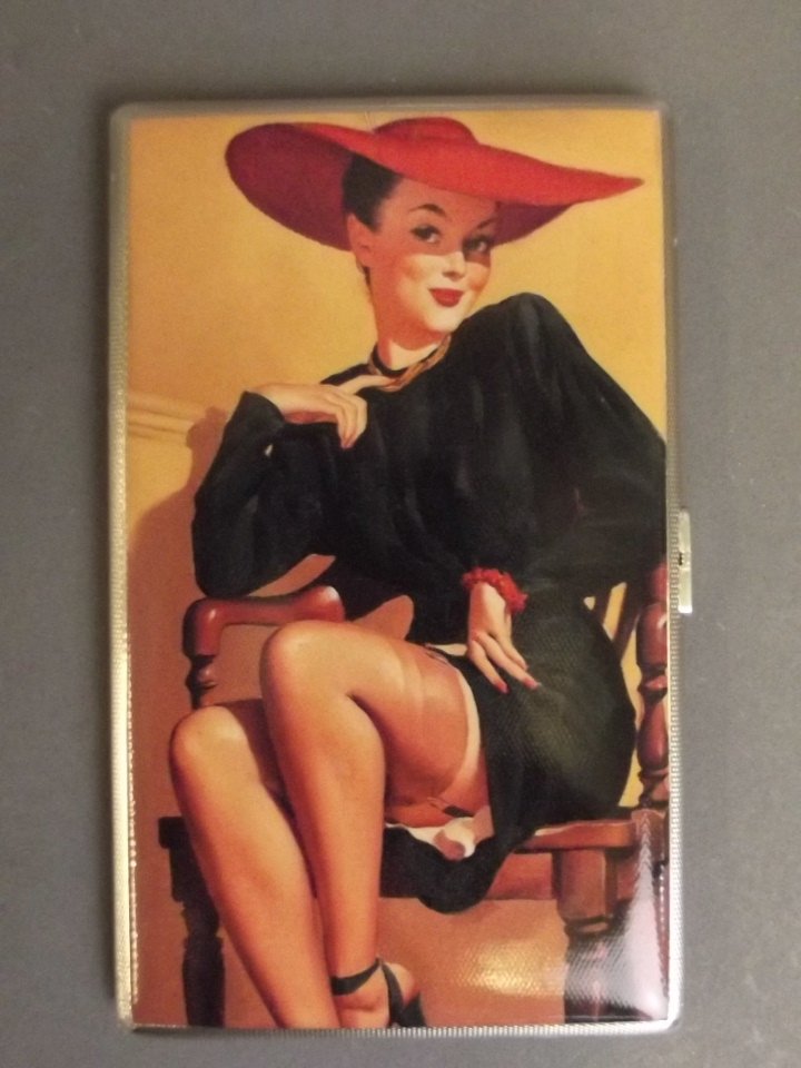 A Hallmarked silver engine turned cigarette case with: A Hallmarked silver engine turned cigarette case with later applied pictorial plaque of a pin up girl in a red hat, London 1933, 3¼'' x 5½''