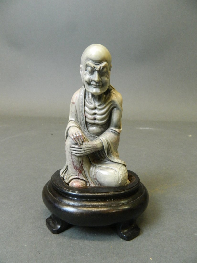 A Chinese carved soapstone figure of Lohan, on a: A Chinese carved soapstone figure of Lohan, on a hardwood base, 6'' high