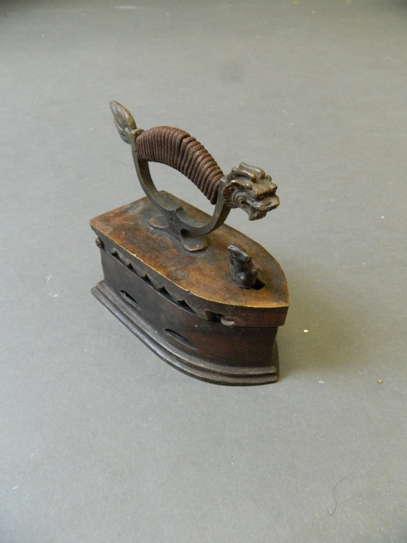 A Chinese brass flat iron with dragon handle, 5'' long: A Chinese brass flat iron with dragon handle, 5'' long
