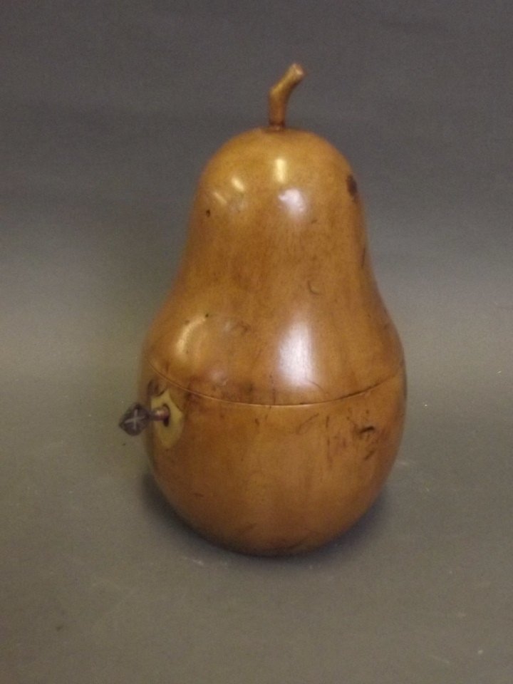 A carved treen tea caddy in the form of a pear, 7'': A carved treen tea caddy in the form of a pear, 7'' high
