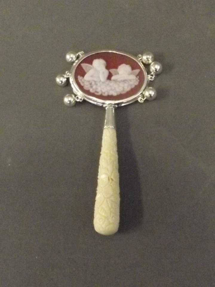 A silver and cameo rattle with a carved handle, 4'': A silver and cameo rattle with a carved handle, 4'' long