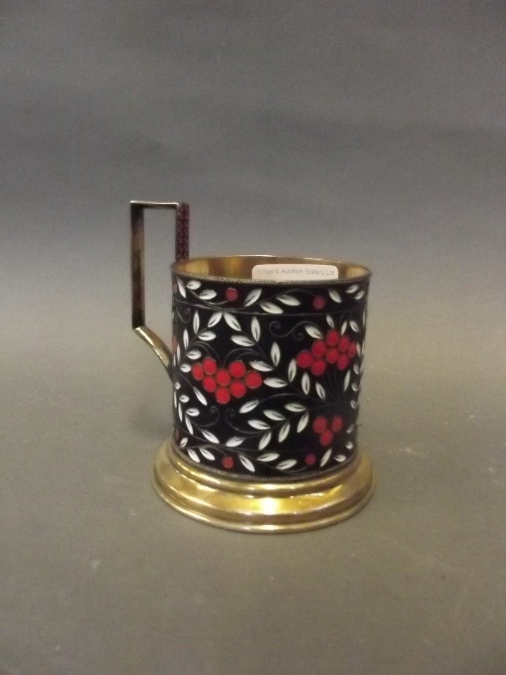 A Russian silver gilt glass holder with enamelled: A Russian silver gilt glass holder with enamelled decoration, 4'' high, 188g
