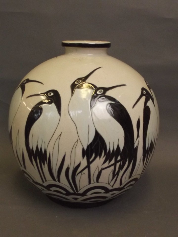 A large bulbous pottery vase decorated with storks,: A large bulbous pottery vase decorated with storks, 12'' high