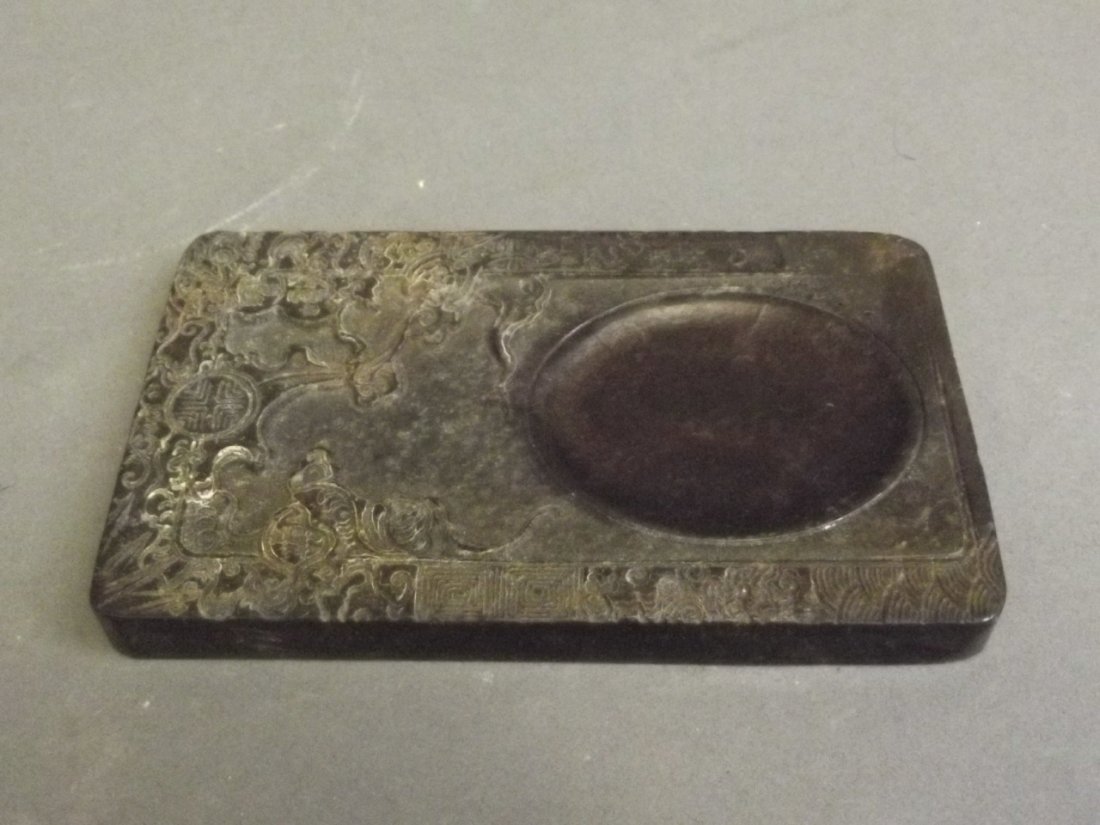 A Chinese hardstone ink wash with carved stylised tree: A Chinese hardstone ink wash with carved stylised tree decoration, 3¾'' x 2½''