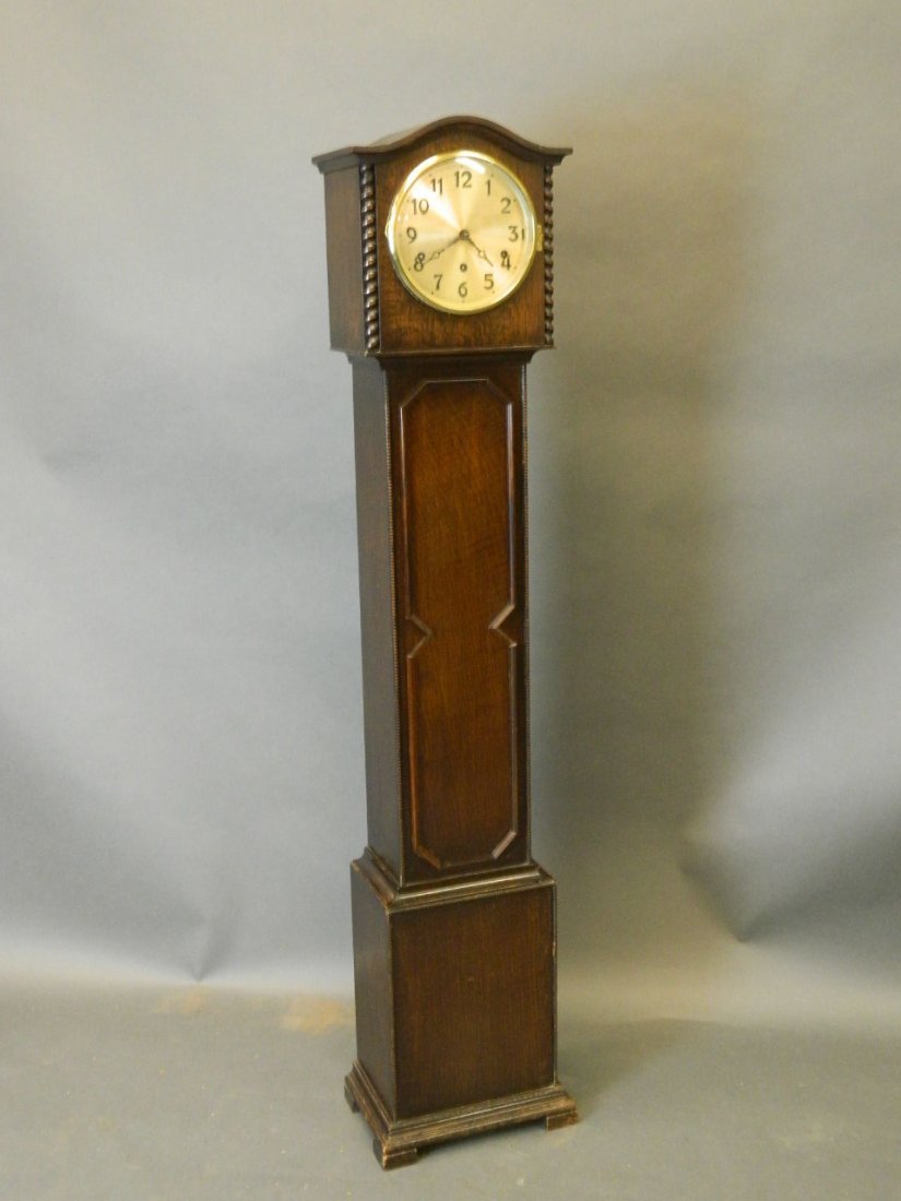 A 1930s oak cased Grandmother clock with Westminster: A 1930s oak cased Grandmother clock with Westminster chimes, 54'' high