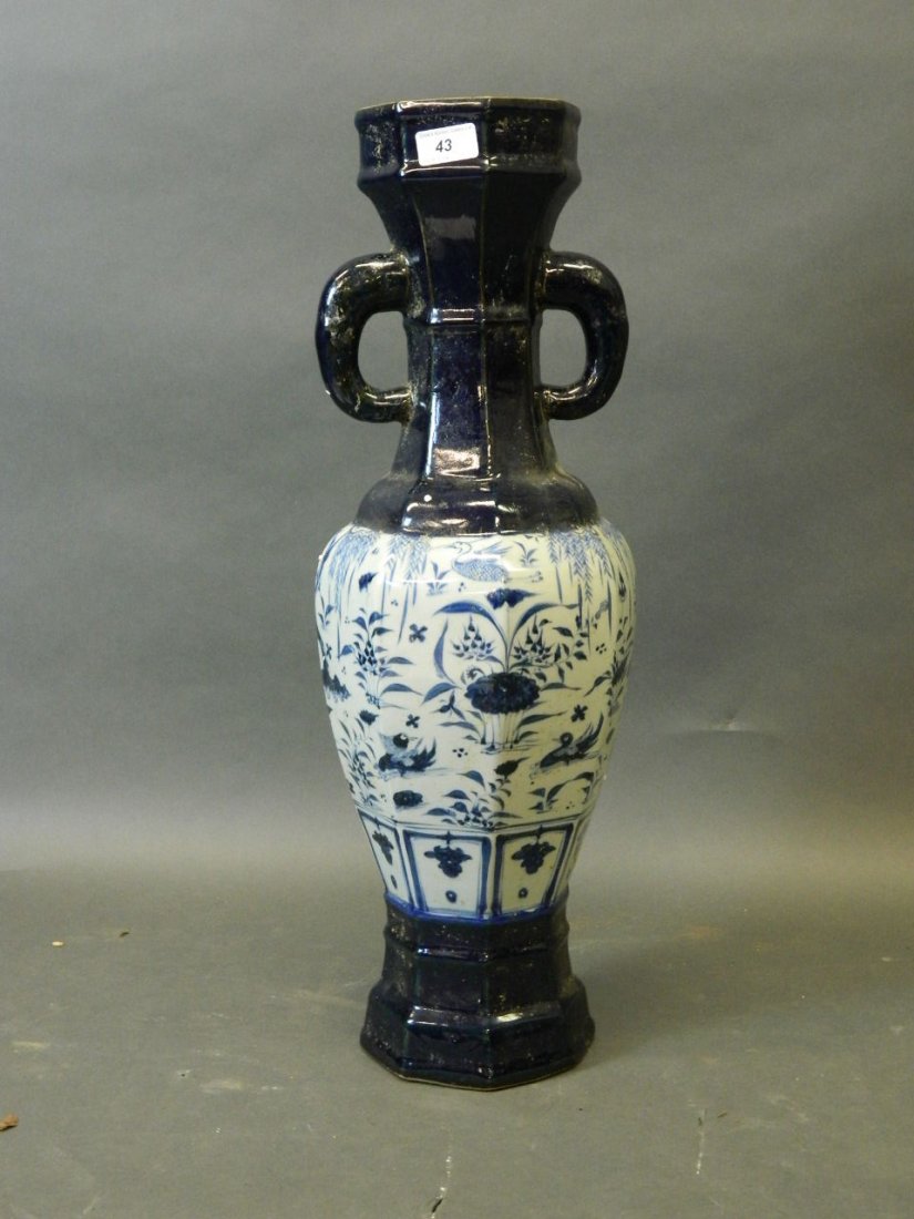 A large Chinese pottery twin handled vase, the base and: A large Chinese pottery twin handled vase, the base and top overglazed in deep blue, the body with blue and white decoration of waterfowl under willow trees, marked plaue to base, 25'' high