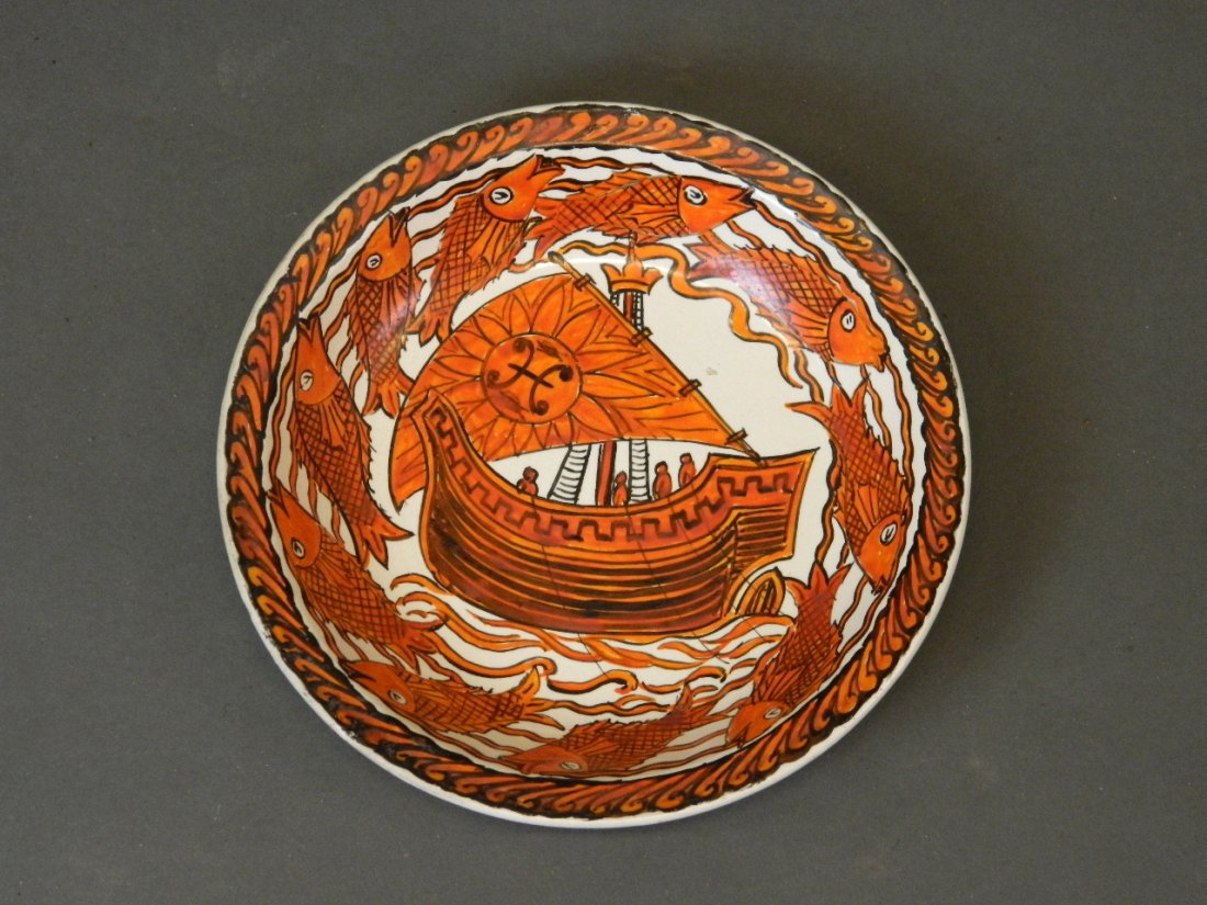 A William De Morgan pottery dish painted by John: A William De Morgan pottery dish painted by John Pearson, with a central galleon and an outer frieze of fish, 8?'' diameter