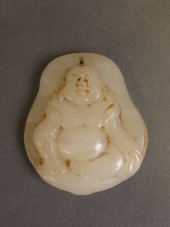 A Chinese white jade pendant with carved seated Buddha: A Chinese white jade pendant with carved seated Buddha decoration, 2'' long