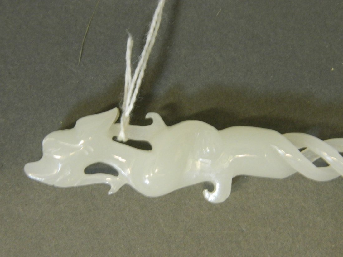 A Chinese pierced jade hair ornament with carved dragon: A Chinese pierced jade hair ornament with carved dragon top, 9½'' long