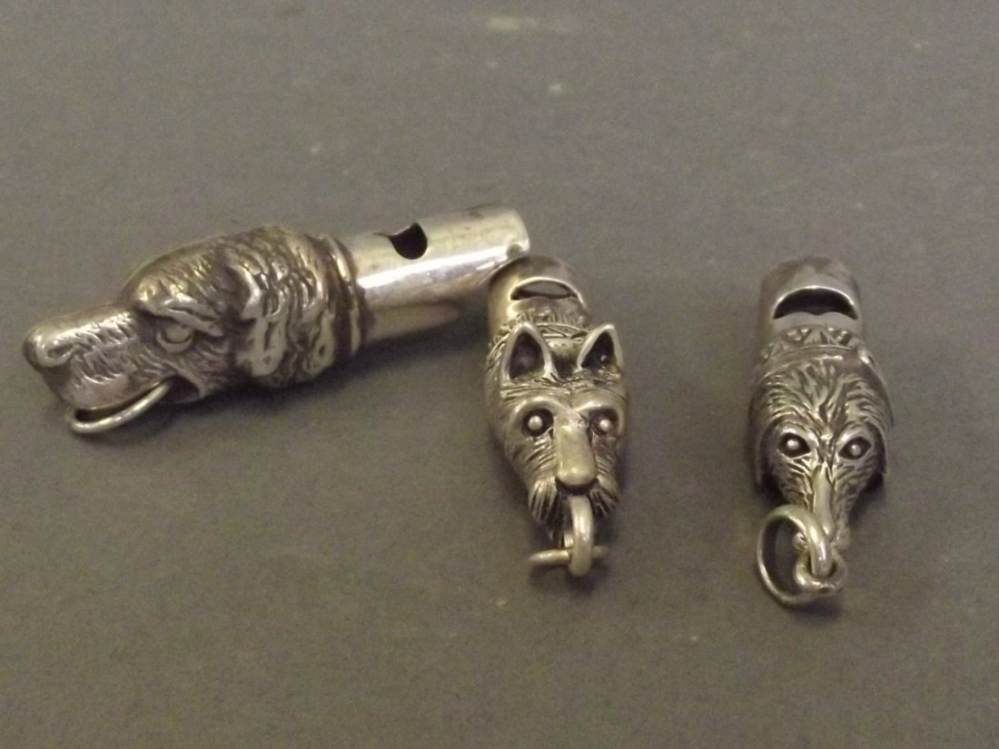 Three Continental silver whistles in the form of dogs,: Three Continental silver whistles in the form of dogs, 2'' long
