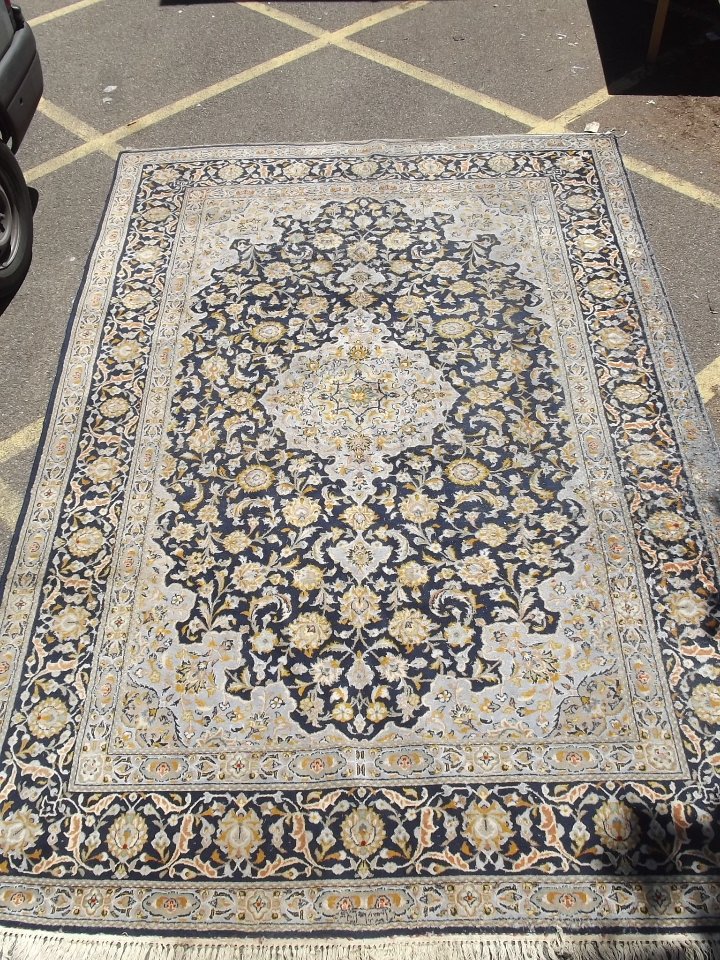 A large Persian blue ground carpet with a central: A large Persian blue ground carpet with a central medallion, 142'' x 100''