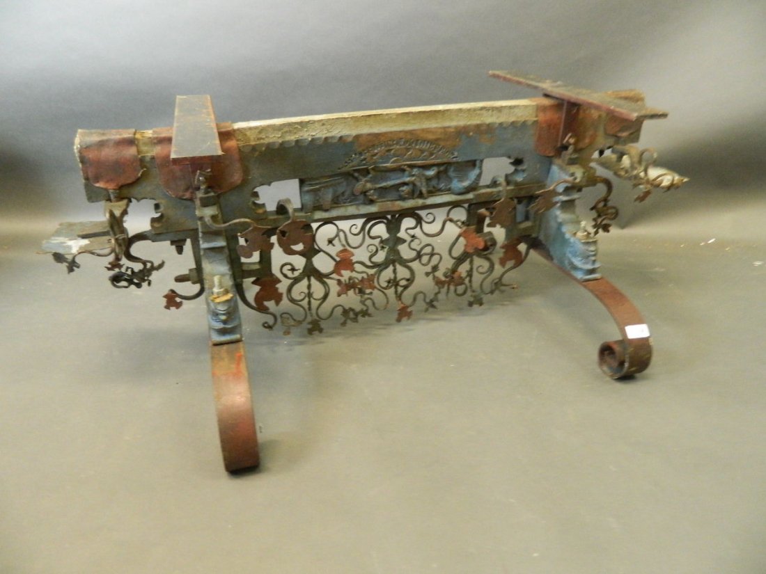 An antique Italian carved wood and wrought iron coffee: An antique Italian carved wood and wrought iron coffee table base, 42½'' x 25'', 16½'' high