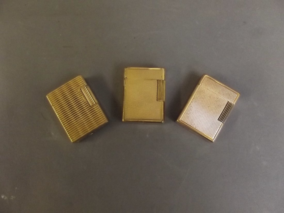 Three gold plated Dupont lighters with engine turned: Three gold plated Dupont lighters with engine turned decoration, 2'' long