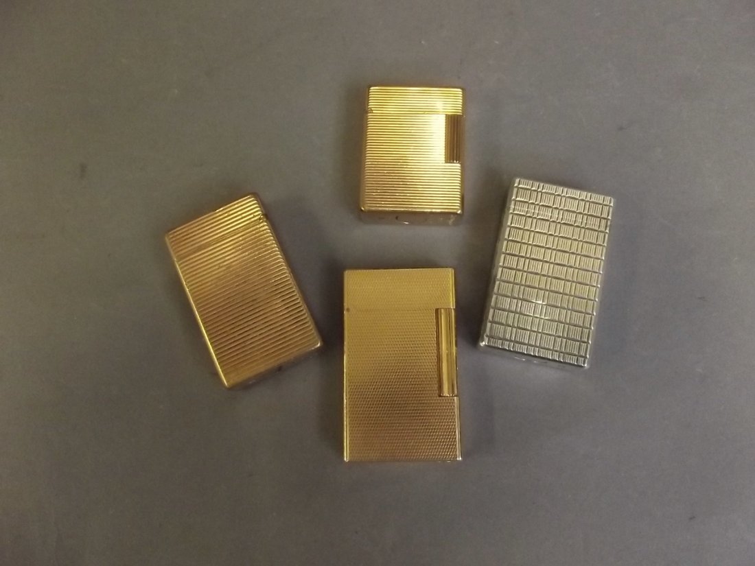 Three gold plated Dupont lighters, and one silver: Three gold plated Dupont lighters, and one silver plated lighter with engine turned decoration, 2¼'' long
