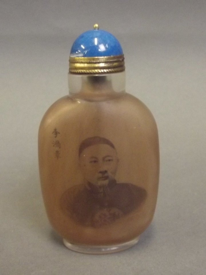 A Peking glass snuff bottle with reverse painted: A Peking glass snuff bottle with reverse painted decoration of a Chinese gentleman and inscriptions, 3¾'' high