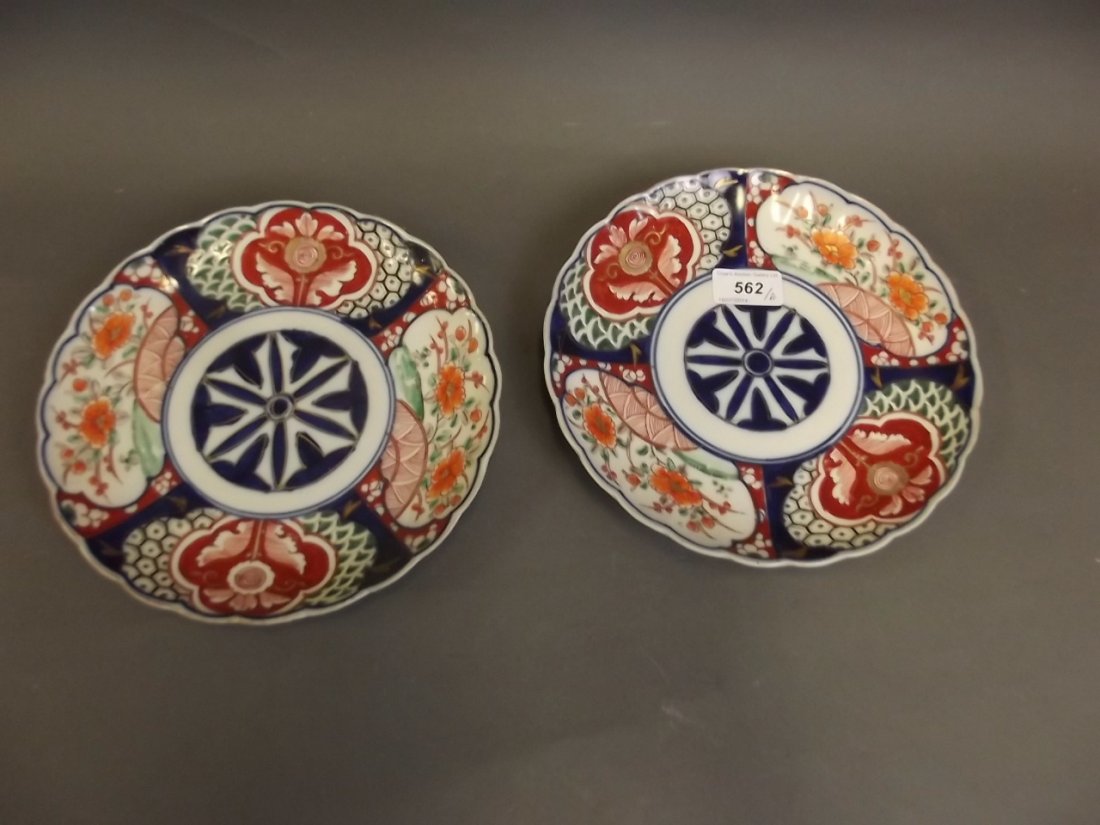 A pair of C19th Japanese Imari dishes painted with: A pair of C19th Japanese Imari dishes painted with flowers, 8¾'' diameter