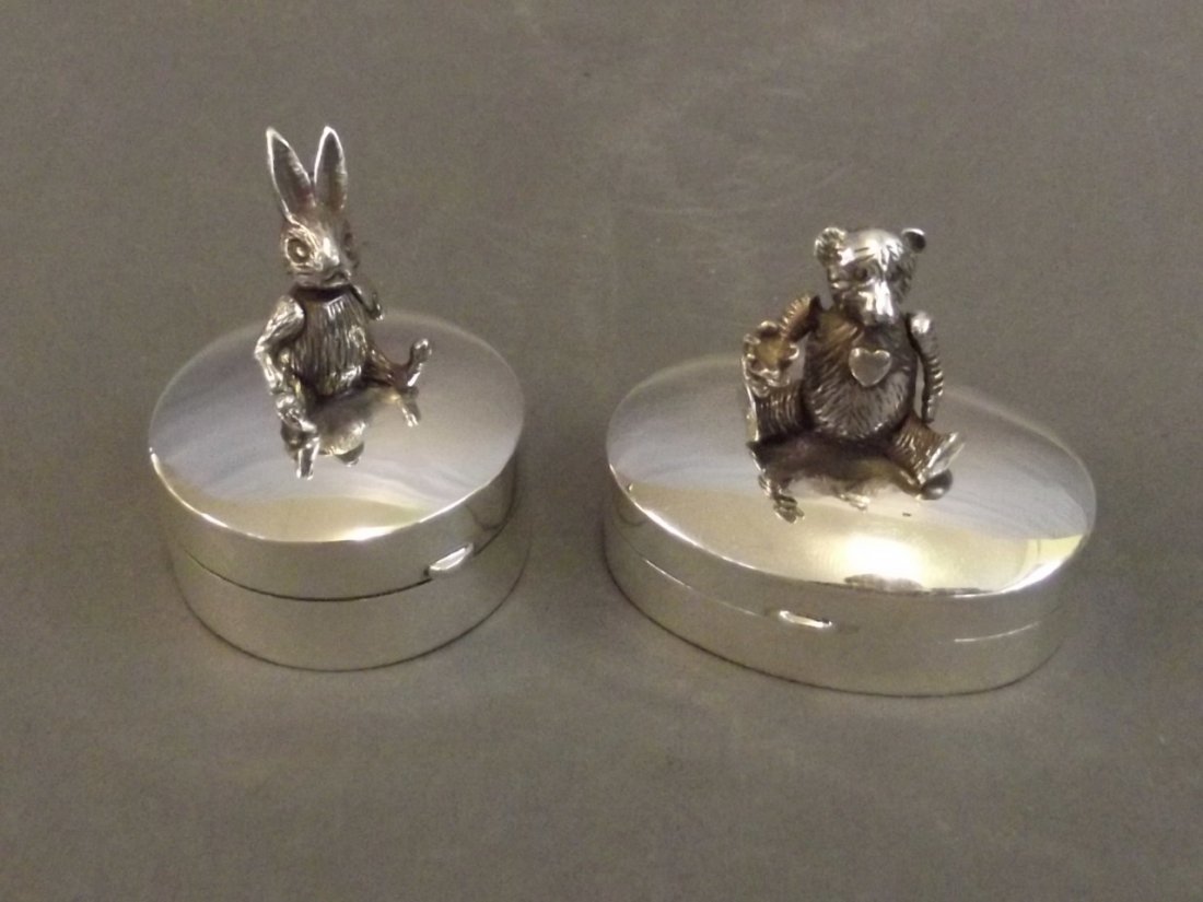 Two 925 silver pill boxes decorated with an articulated: Two 925 silver pill boxes decorated with an articulated bear and rabbit, 1½'' long