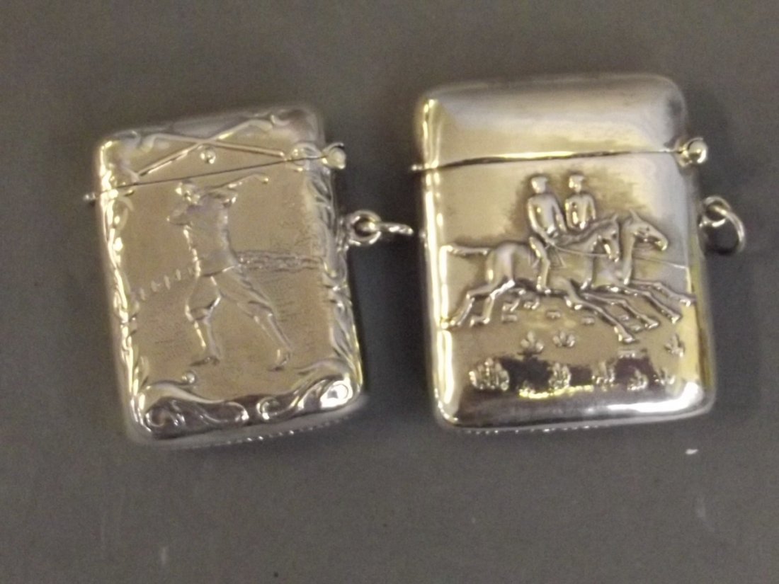 Two Continental silver vesta cases decorated with: Two Continental silver vesta cases decorated with sporting themes, 2'' long