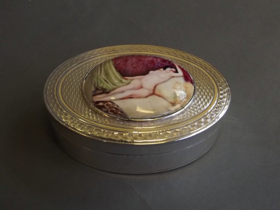 An oval Hallmarked silver snuff box with later applied: An oval Hallmarked silver snuff box with later applied cold enamel plaque of a reclining nude woman, London, 2¾'' x 2''